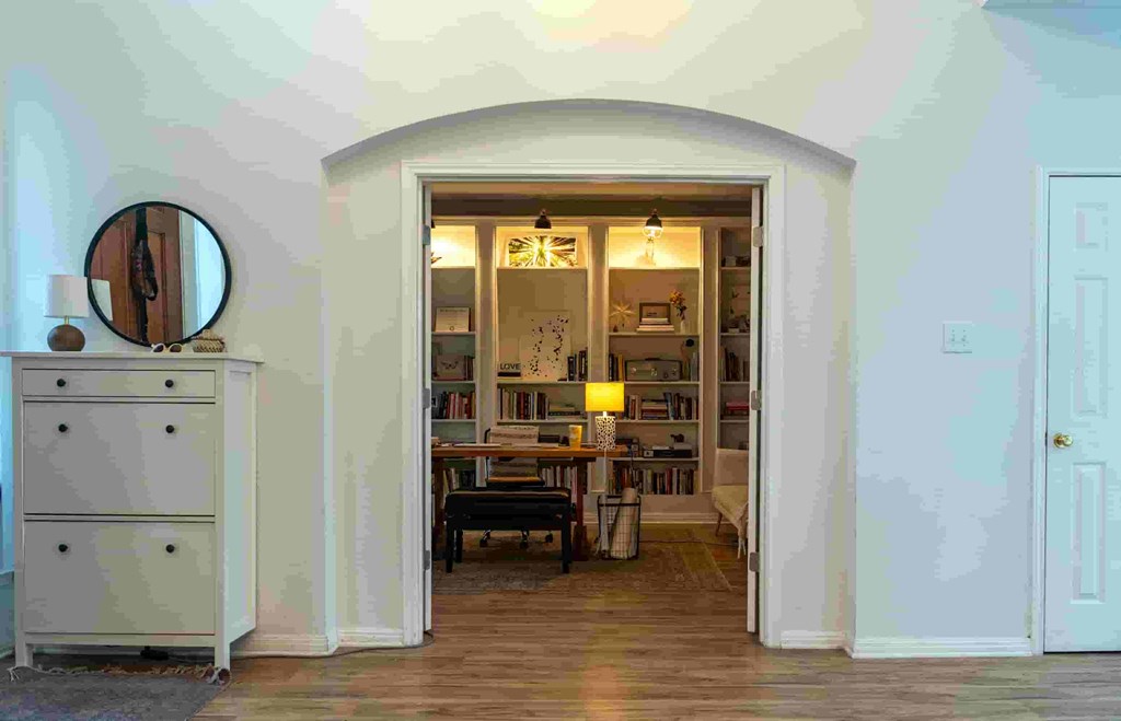 A room with a white doorway leading to a living room and dining room.