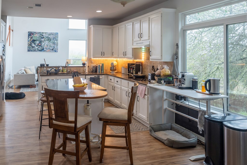 A kitchen with a table and chairs in the middle of the room.