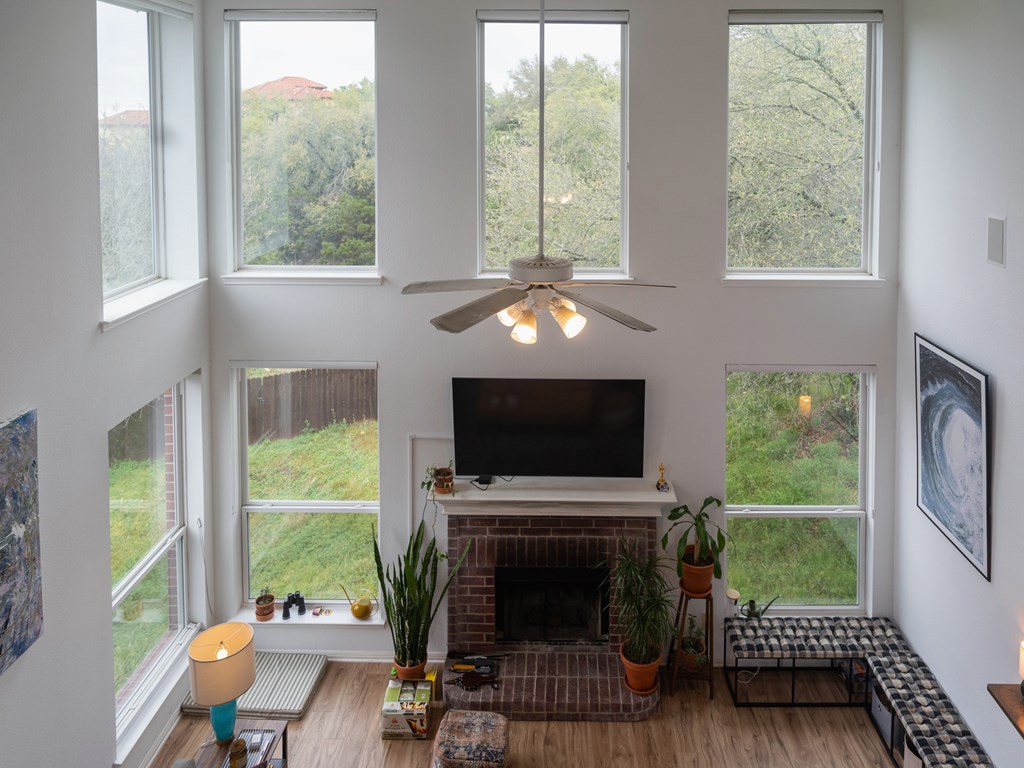 A living room with a fireplace and a television.