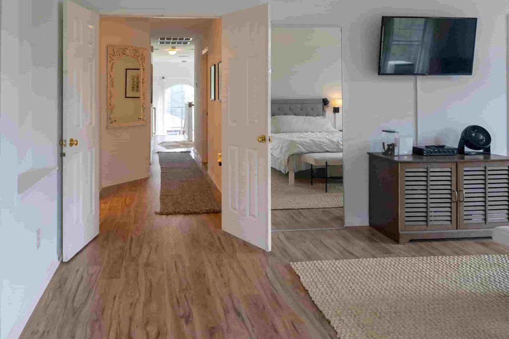 A room with a bed, a desk, and a television.