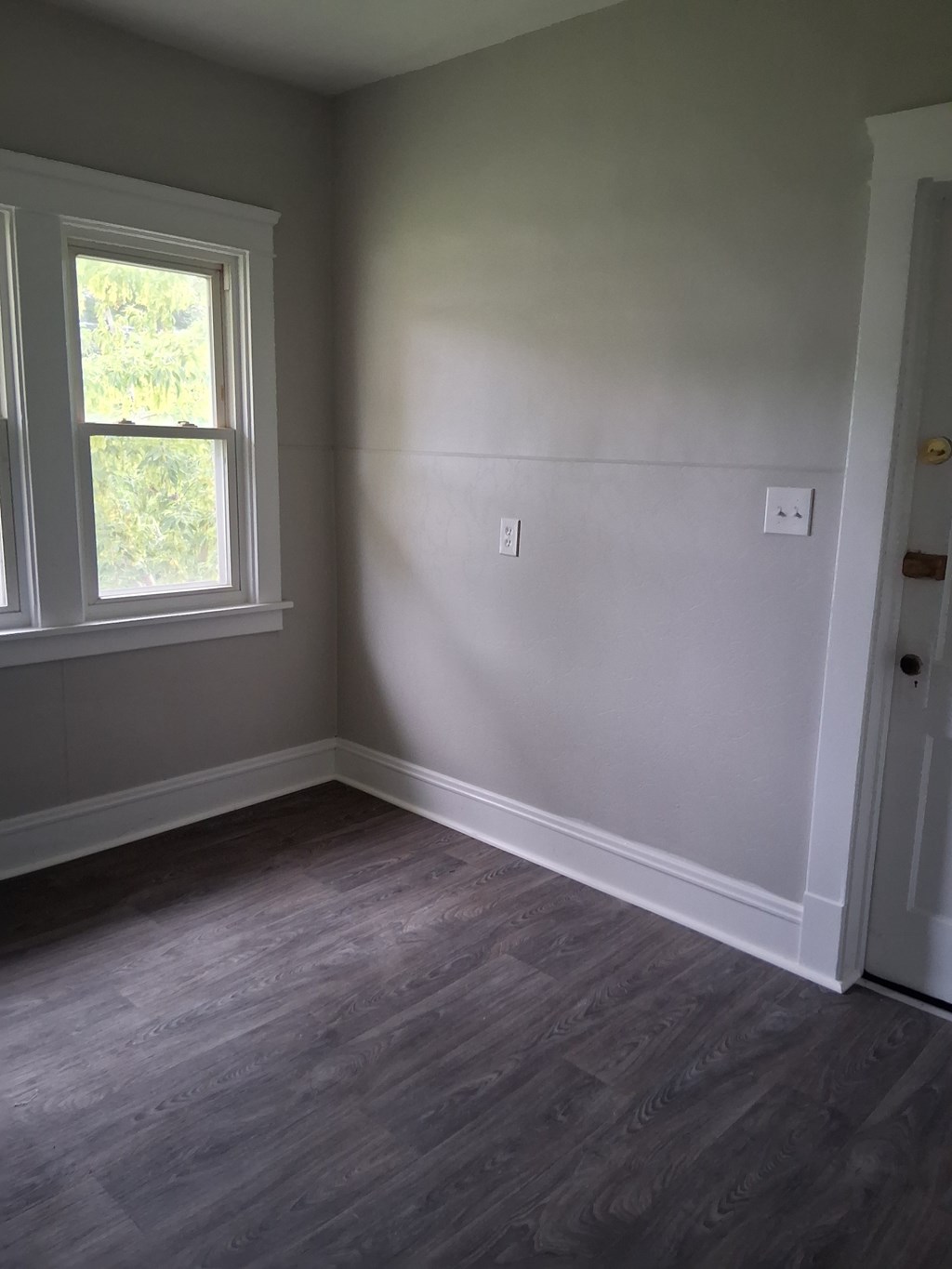 A room with a window and a door.