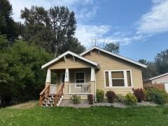 A small house with a porch and a small garden in front.