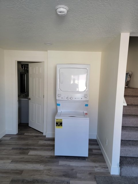 A small white fridge with a sticker on it.