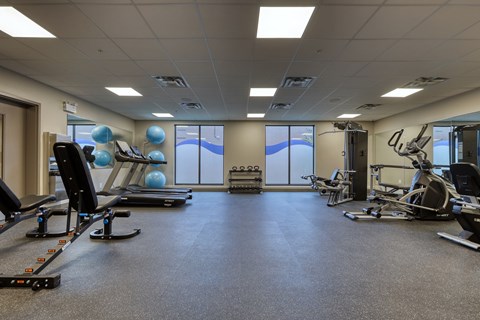 A spacious gym with a variety of exercise equipment.