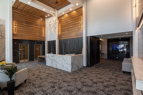 A reception area with a wooden ceiling and a grey carpet.