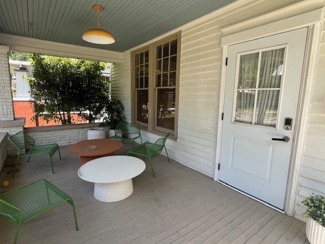 A white door is on the right side of a porch.