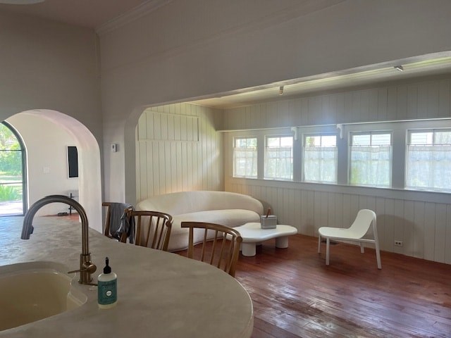 A kitchen with a sink, a chair, and a table.