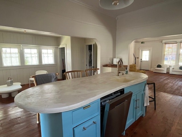 A kitchen with a large island and blue cabinets.