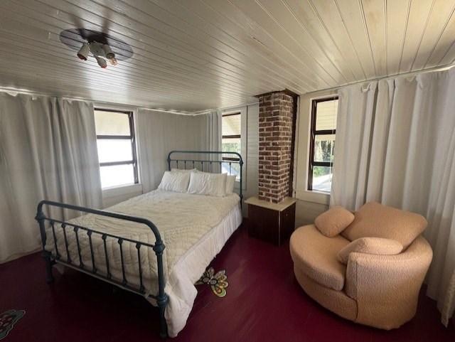 A bedroom with a bed, chair, and a ceiling fan.