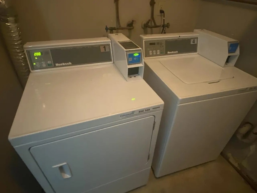 Two white ovens with digital displays on top.