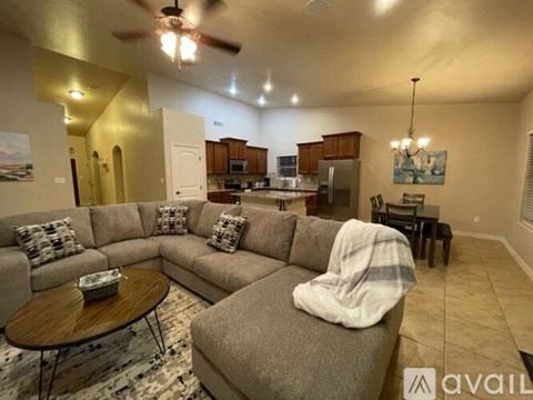 A living room with a grey couch and a coffee table.