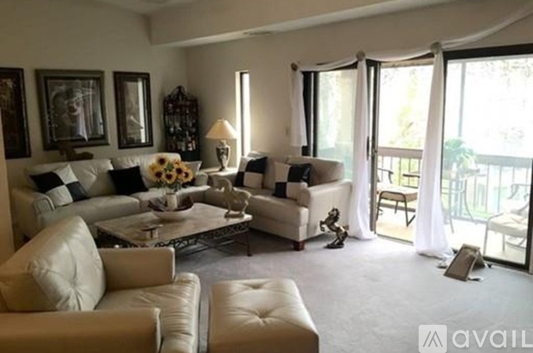 A living room with a white couch and a coffee table.
