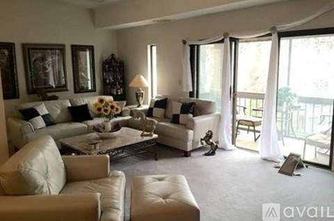 A living room with a white couch and a coffee table.