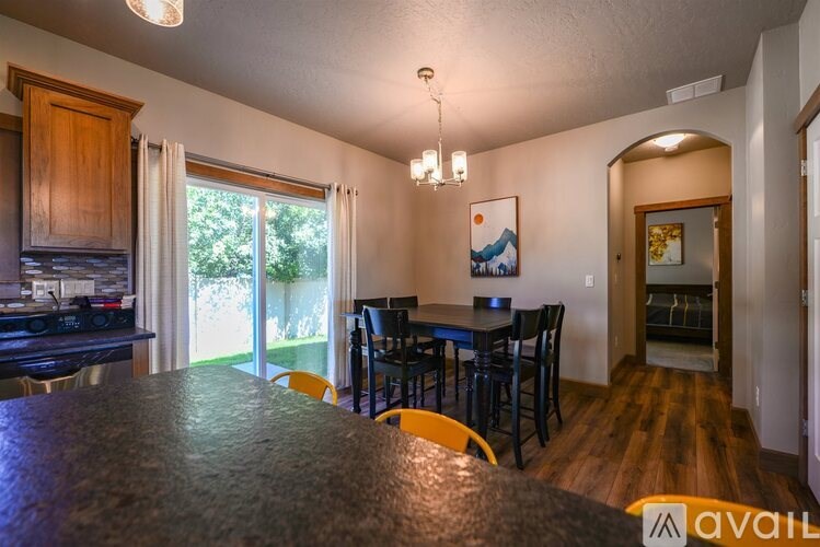 A kitchen with a dining table and chairs.