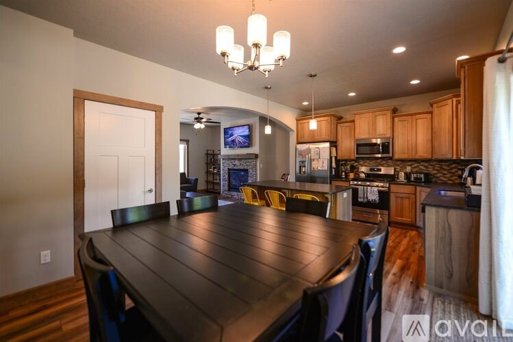 A modern kitchen with a wooden table and chairs.