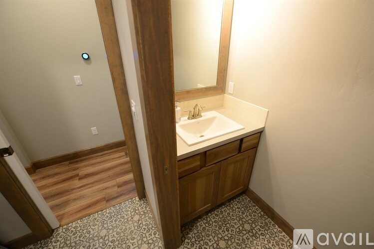 A bathroom with a sink and mirror.