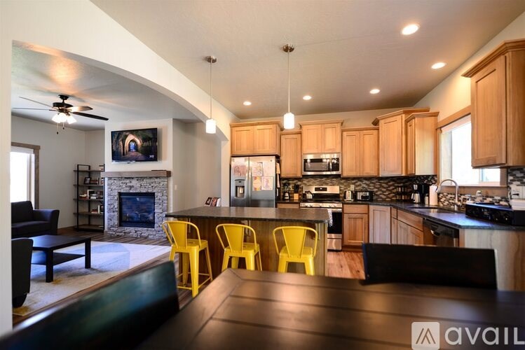 A modern kitchen with wooden cabinets and a black countertop.