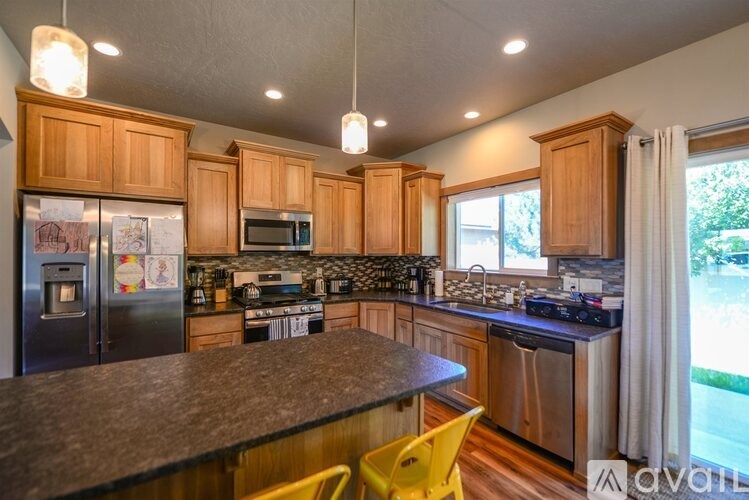 A kitchen with wooden cabinets and a granite countertop.