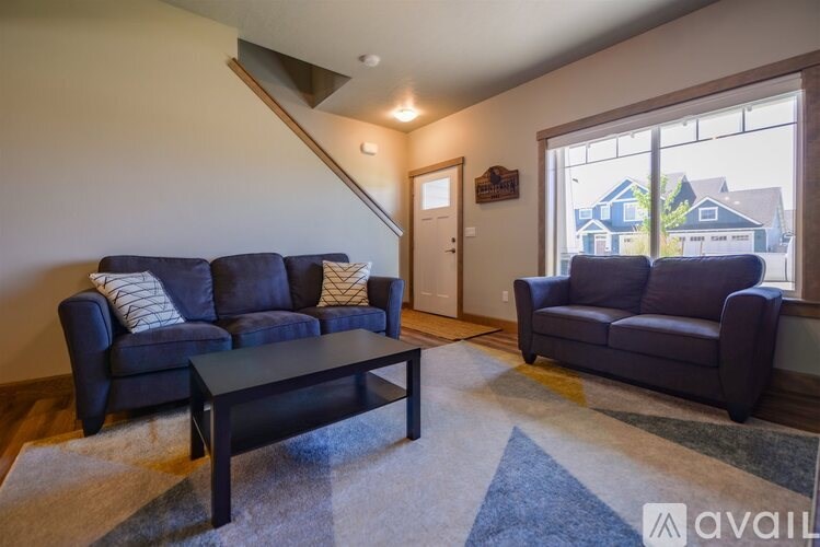 A living room with a dark blue sofa and a black coffee table.