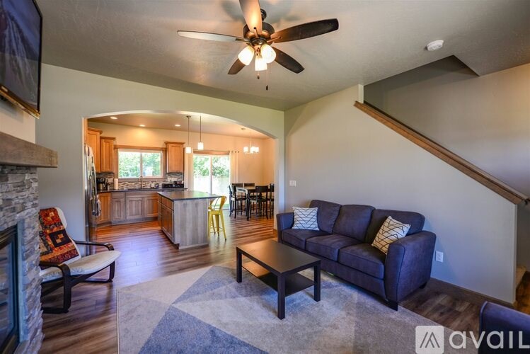 A living room with a couch, chairs, and a coffee table.