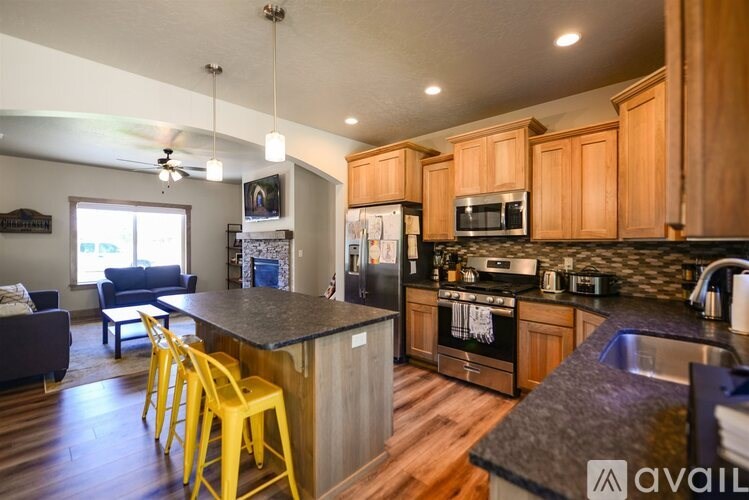 A kitchen with wooden cabinets and a black countertop.