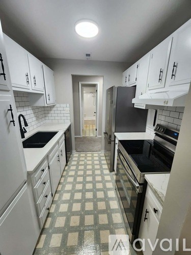 A kitchen with white appliances and cabinets.