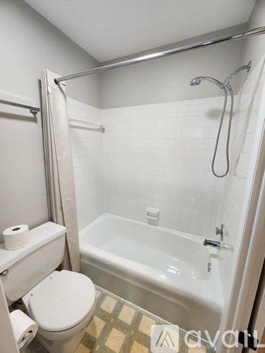 A bathroom with a white sink and a white shower curtain.