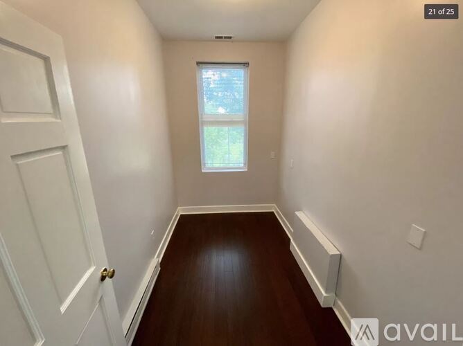 A room with a door on the left and a window on the right.