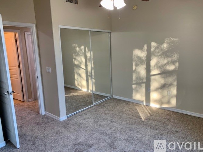 A room with a carpeted floor and a sliding glass door.