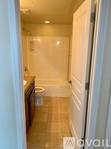 A bathroom with a toilet, sink, and bathtub.