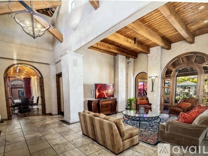 A living room with a couch, chairs, and a coffee table.