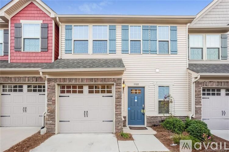 A two-story house with a red and beige exterior and a blue front door.