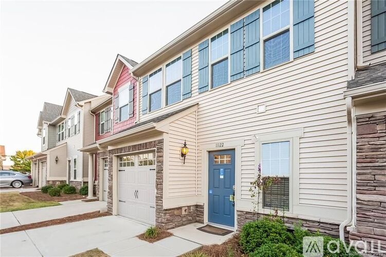 A row of houses with the number 1122 on the front door.