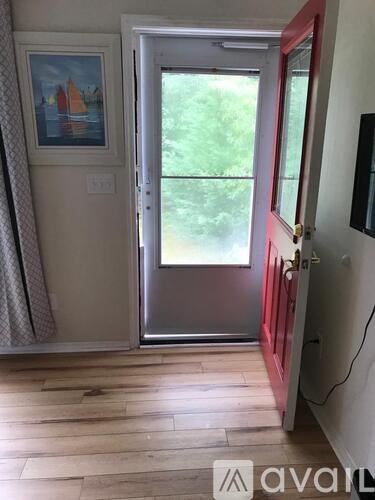A red door with a window in front of it.