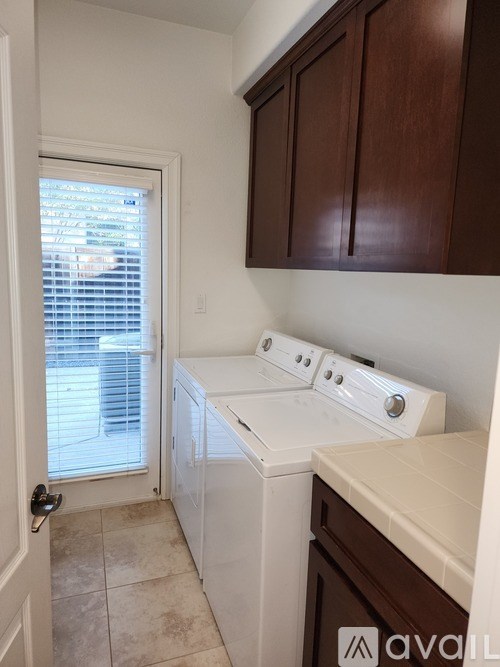 A small laundry room with a washer and dryer.