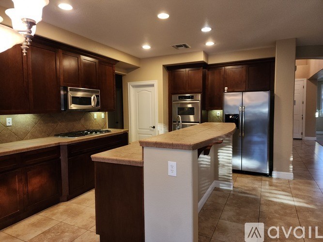 A kitchen with brown cabinets and a white island.