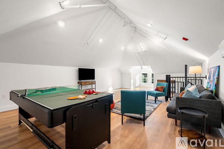 A room with a pool table and a couch.