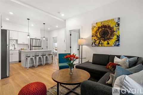 A modern living room with a grey couch and a wooden coffee table.