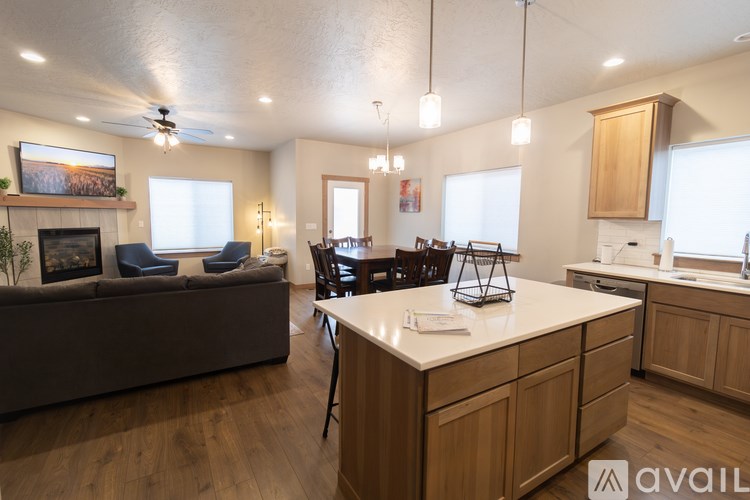 A living room with a couch, chairs, and a fireplace.