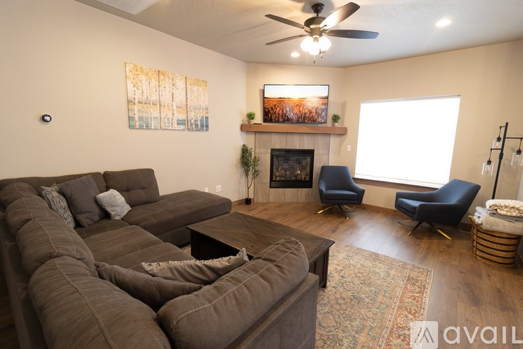 A living room with a large couch and a fireplace.