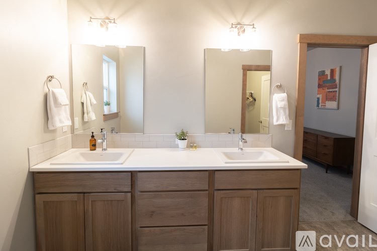 A bathroom with two sinks and a large mirror.