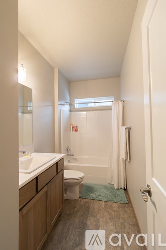 A bathroom with a toilet, sink, and bathtub.