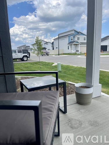 A patio with a table and chairs overlooking a street.