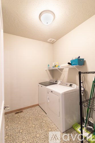 A small laundry room with a washer and dryer.