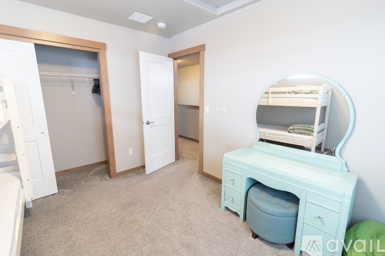 A room with a desk and a bunk bed.