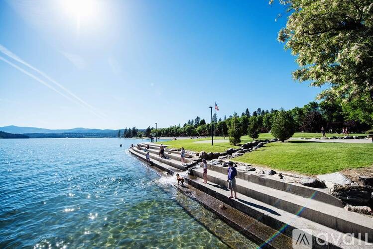 A sunny day at the lake with people enjoying the water.