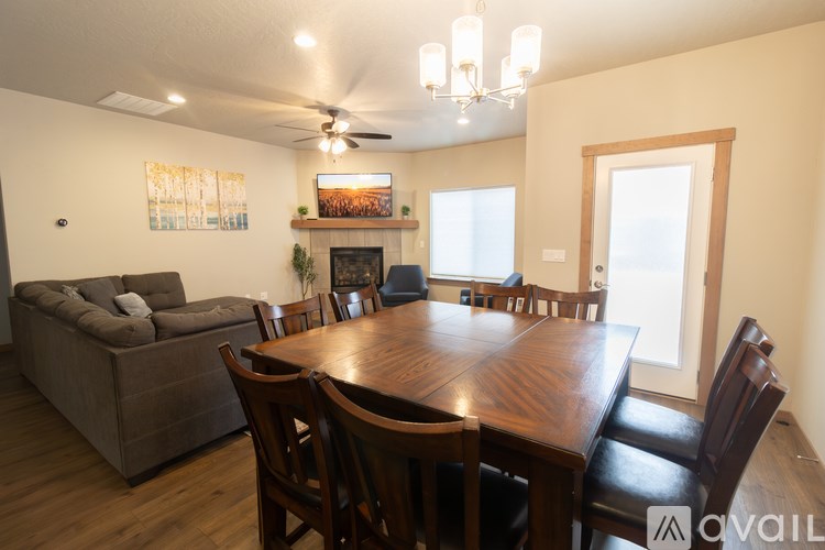 A dining room with a wooden table and chairs.