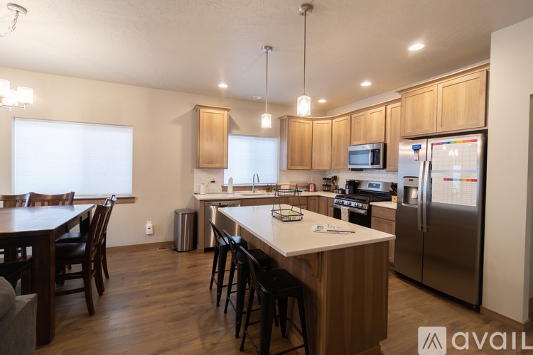 A kitchen with wooden cabinets and a white island with a countertop.