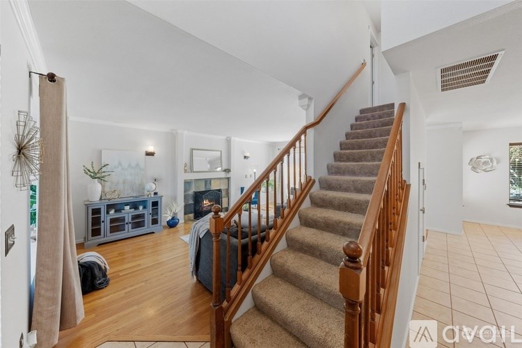A living room with a staircase leading to the upper floor.