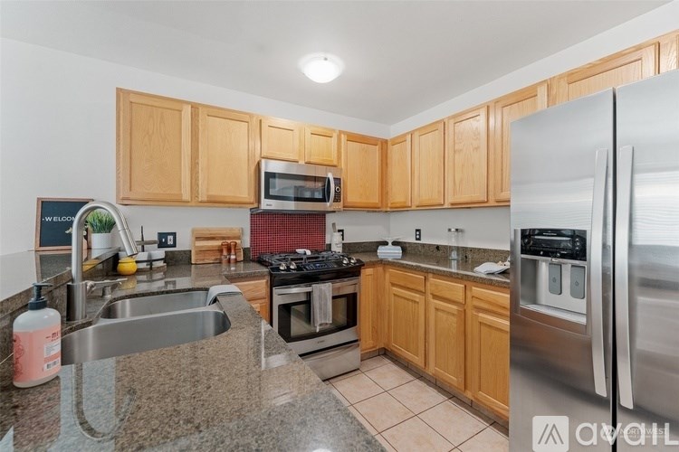 A kitchen with wooden cabinets and stainless steel appliances.